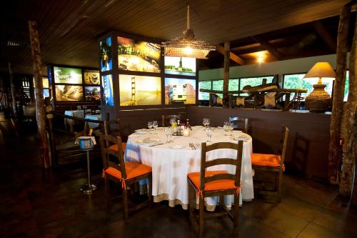 a dining room with a table and chairs in a restaurant at Catalonia Punta Cana - All Inclusive in Punta Cana