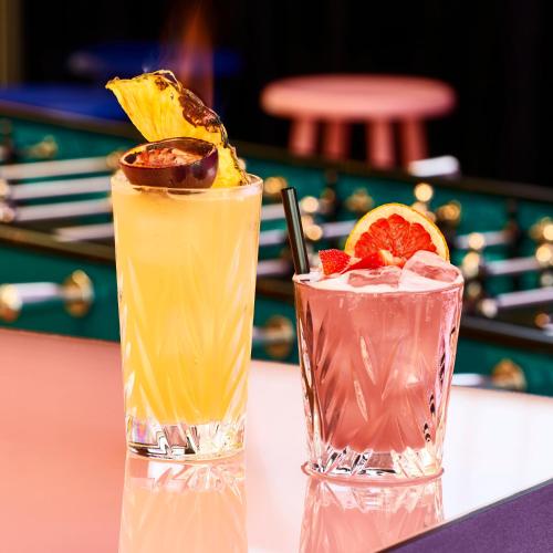 two cocktails sitting on top of a table at Mama Shelter Prague in Prague