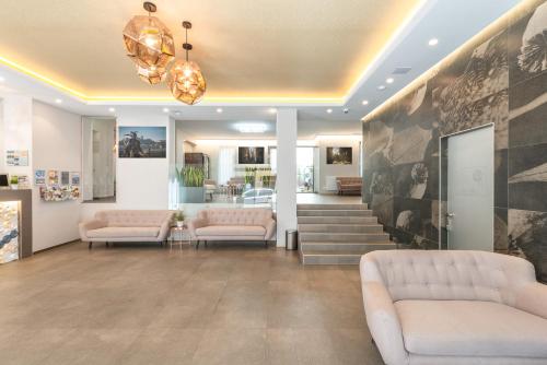 a lobby with couches and a staircase in a building at Corvin Plaza Apartments & Suites in Budapest