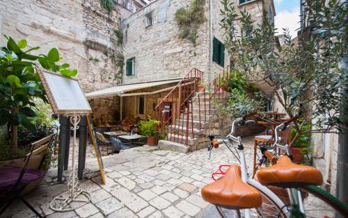 a bike parked in front of a building at Pylon Rooms in Split