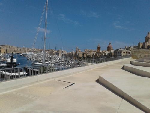 a bridge over a harbor with boats in the water at townhouse cospicua , ( 3 cities-valletta ) ferry in Cospicua