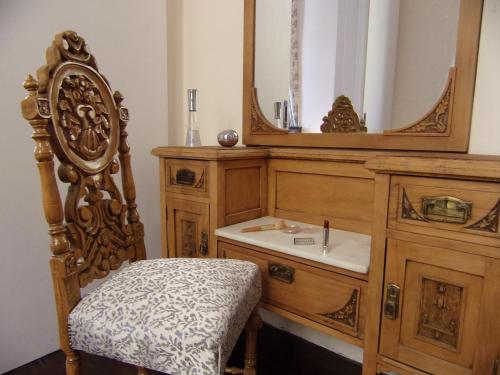 a bathroom with a wooden vanity with a sink and a mirror at Finestra Rossa old town vintage house in Lefkada Town