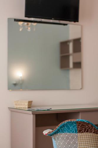 a mirror on top of a desk in a room at Case Vacanze Al Duomo in Licata