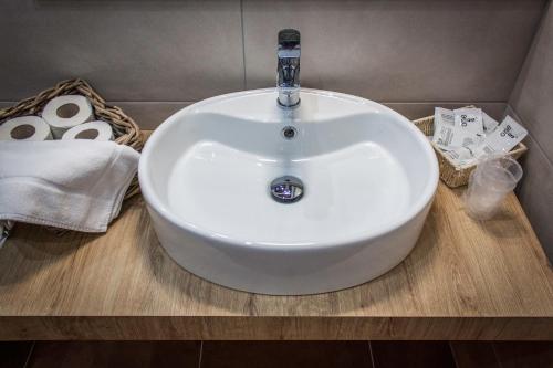 a white sink sitting on a counter in a bathroom at Case Vacanze Al Duomo in Licata