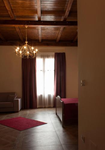 a living room with a window and a chandelier at Case Vacanze Al Duomo in Licata