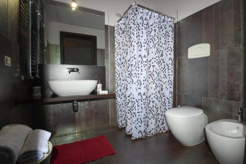 a bathroom with a sink and a toilet and a shower at La Torre-1984 in Sarnelli