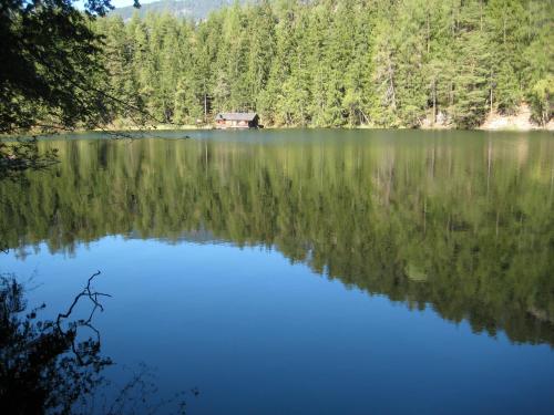 a lake with a house in the middle of it at Haus Tirolerland in Oetz