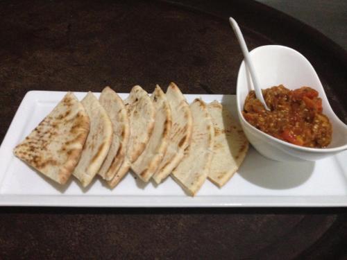 a plate of food with sandwiches and a bowl of salsa at Jamaica Palace Hotel in Port Antonio