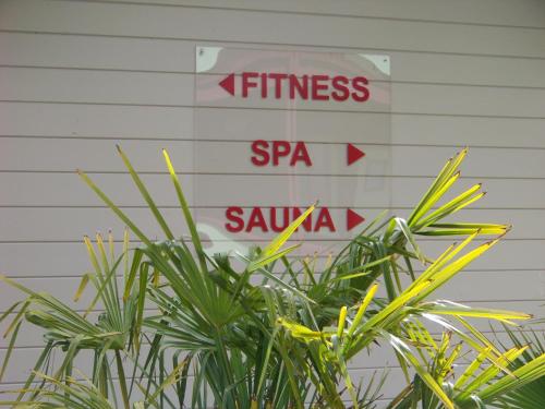 a sign that says fitness and spa sauza behind a plant at Hotel Nuit Et Jour - La Maison de Lucile in Cancale