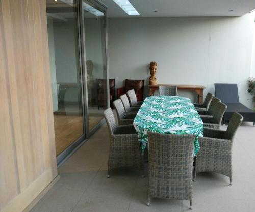 a dining room with a table and chairs at 23 Grace in Cape Town