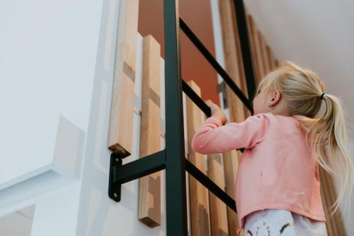 a little girl is standing next to a wall at Hotel Jerom in Kalmthout