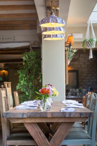 a wooden table with a cake on top of it at The Frogmill Hotel in Cheltenham