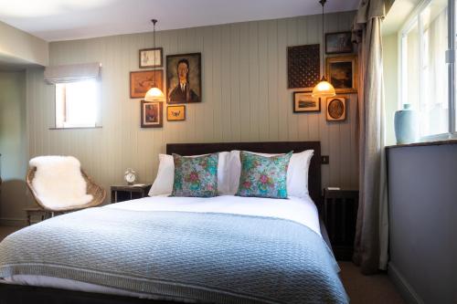 a bedroom with a bed and pictures on the wall at The Frogmill Hotel in Cheltenham
