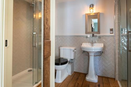 a bathroom with a toilet and a sink and a shower at The Frogmill Hotel in Cheltenham