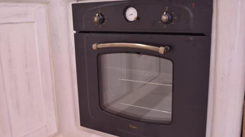 a black oven with its door open in a kitchen at Iphimedeia Luxury Hotel & Suites in Naxos Chora