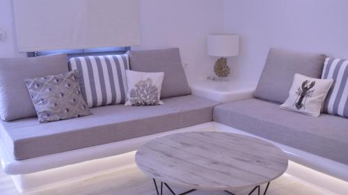 a living room with a couch and a table at Iphimedeia Luxury Hotel & Suites in Naxos Chora
