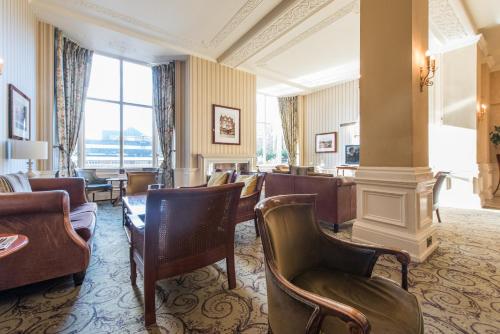 a hotel lobby with chairs and a waiting room at Cairn Hotel in Harrogate
