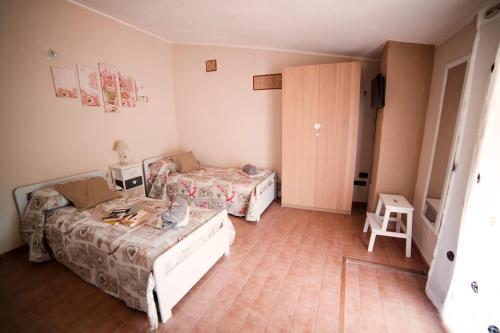 a room with two beds and a table in it at Ambrosia in Pozzilli