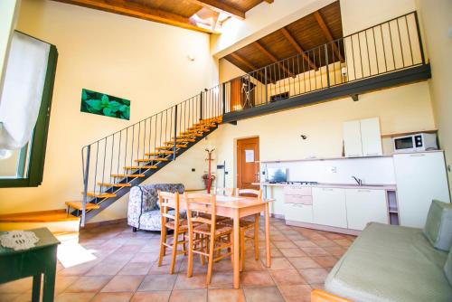 a kitchen and a dining room with a table and chairs at Agriturismo Turina in Bricherasio