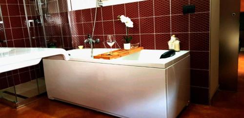 a bathroom with a white tub and a sink at Hotel I Narcisi in Siniscola