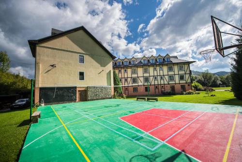 
a green and white tennis court with a tennis racket on top of it at Hotel Golfer in Kremnica
