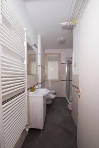 a bathroom with a sink and a toilet at Luxury apartment Garda Lake in Desenzano del Garda