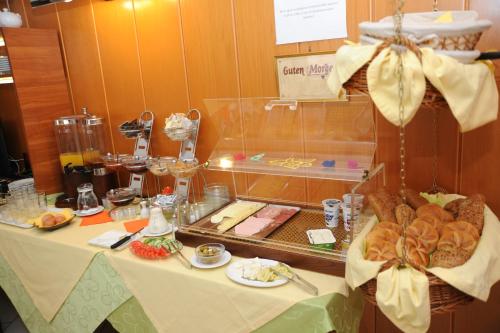 a table with a buffet of food on it at Pension Erlaa in Vienna