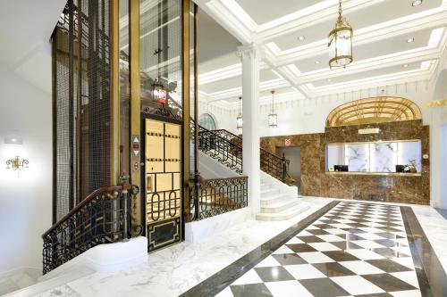 a lobby with a black and white checkered floor at Eurostars Hotel Real in Santander