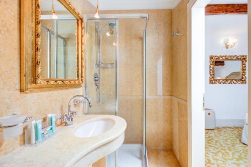 a bathroom with a sink and a shower at Hotel Al Duca Di Venezia in Venice