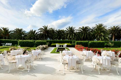 a group of tables and chairs in a garden at Eurostars Hotel Real in Santander