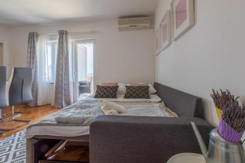 a bedroom with a large bed and a couch at Apartment Ankica L4 in Crikvenica