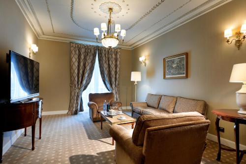 a living room with a couch and a table at Eurostars Hotel Real in Santander