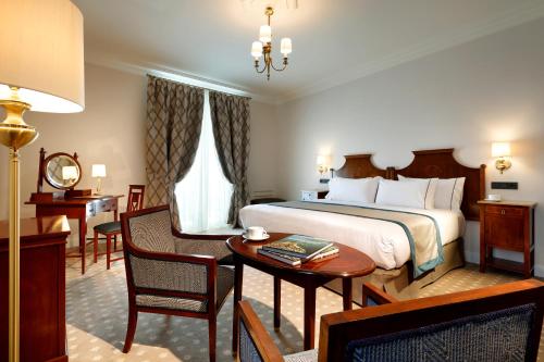 a hotel room with a bed and a table and chairs at Eurostars Hotel Real in Santander