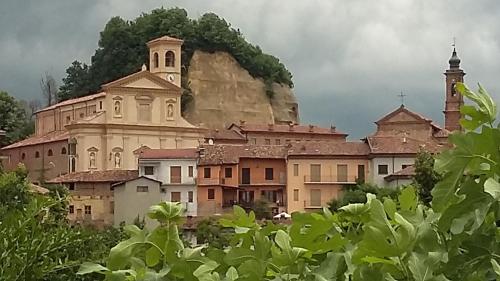 a group of buildings and a church on a mountain at B&B Madonna degli Airali in Vezza d'Alba