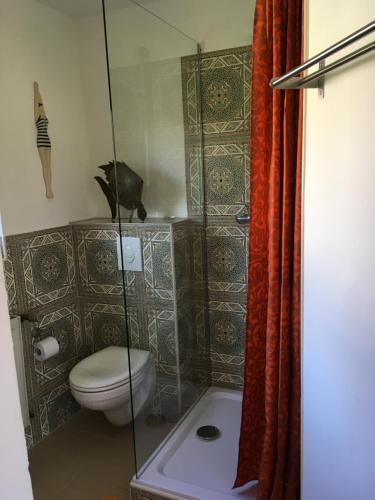 a bathroom with a toilet and a glass shower at Gaestehaus Klaus in Mendig