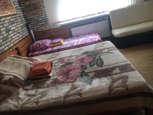 two beds in a room with flowers on it at Будиночок для відпочинку in Odesa