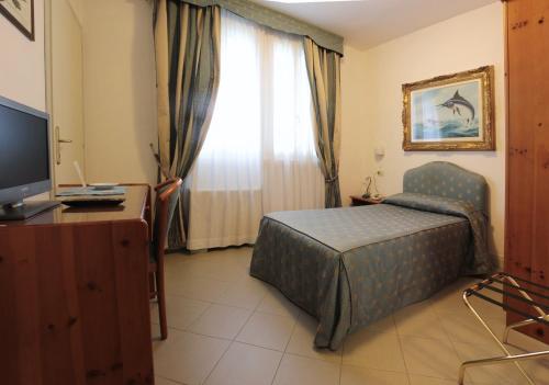 En eller flere senge i et værelse på Hotel Locanda del Passo Pomposa