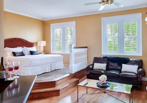 a bedroom with a bed and a couch at Inn at Carnall Hall in Fayetteville