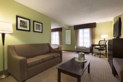 a living room with a couch and a table at Days Inn by Wyndham Baltimore Inner Harbor in Baltimore