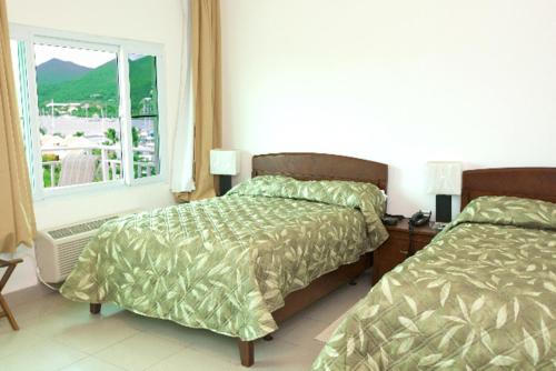 Ένα ή περισσότερα κρεβάτια σε δωμάτιο στο Simpson Bay Suites