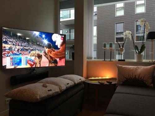 a living room with a flat screen tv on a wall at Førde in Førde