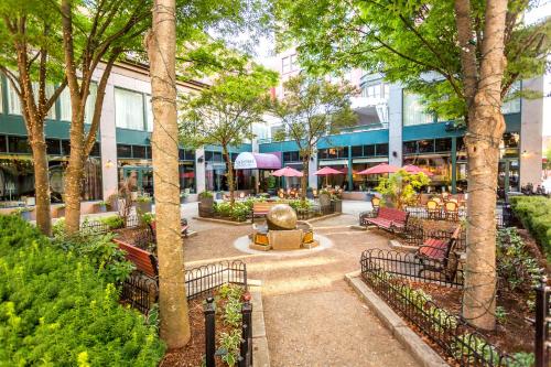 a courtyard with benches and tables and trees at Hotel Providence in Providence