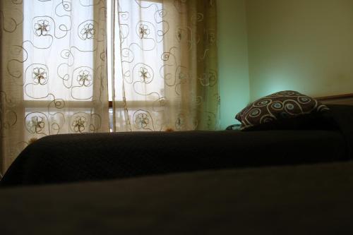 a bedroom with a bed and a window with curtains at Hotel Diana in Cassino