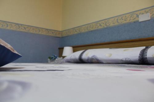 a close up of a bed in a bedroom at Hotel Diana in Cassino