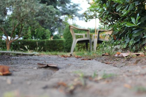 a white chair sitting in the middle of a dirt road at Hotel Diana in Cassino