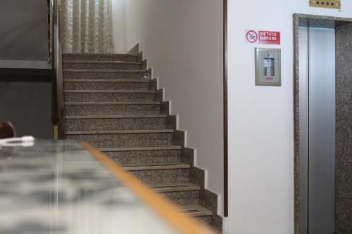 a staircase in a building with a sign on the wall at Hotel Diana in Cassino