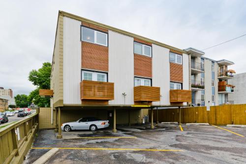 a building with a car parked in a parking lot at M Lofts in Calgary