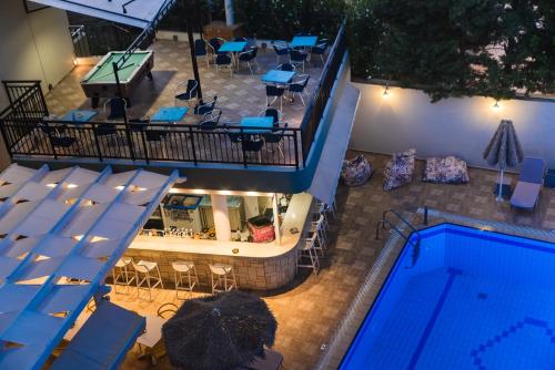 an overhead view of a swimming pool and a restaurant at Natali Apartments by Estia in Malia