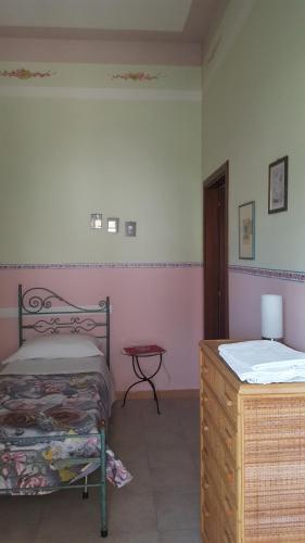 a bedroom with two beds and a table in it at Locanda della Bottega in Fisciano