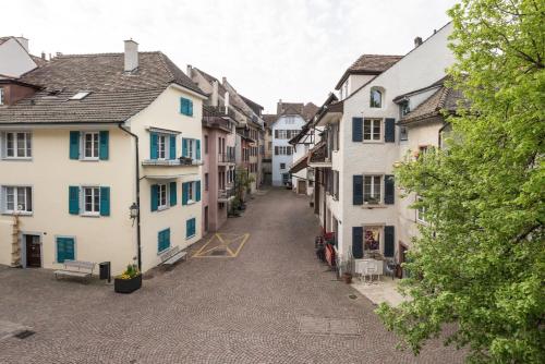 an empty street in a town with white houses at Ferienhaus Altstadt CH-Rheinfelden in Rheinfelden